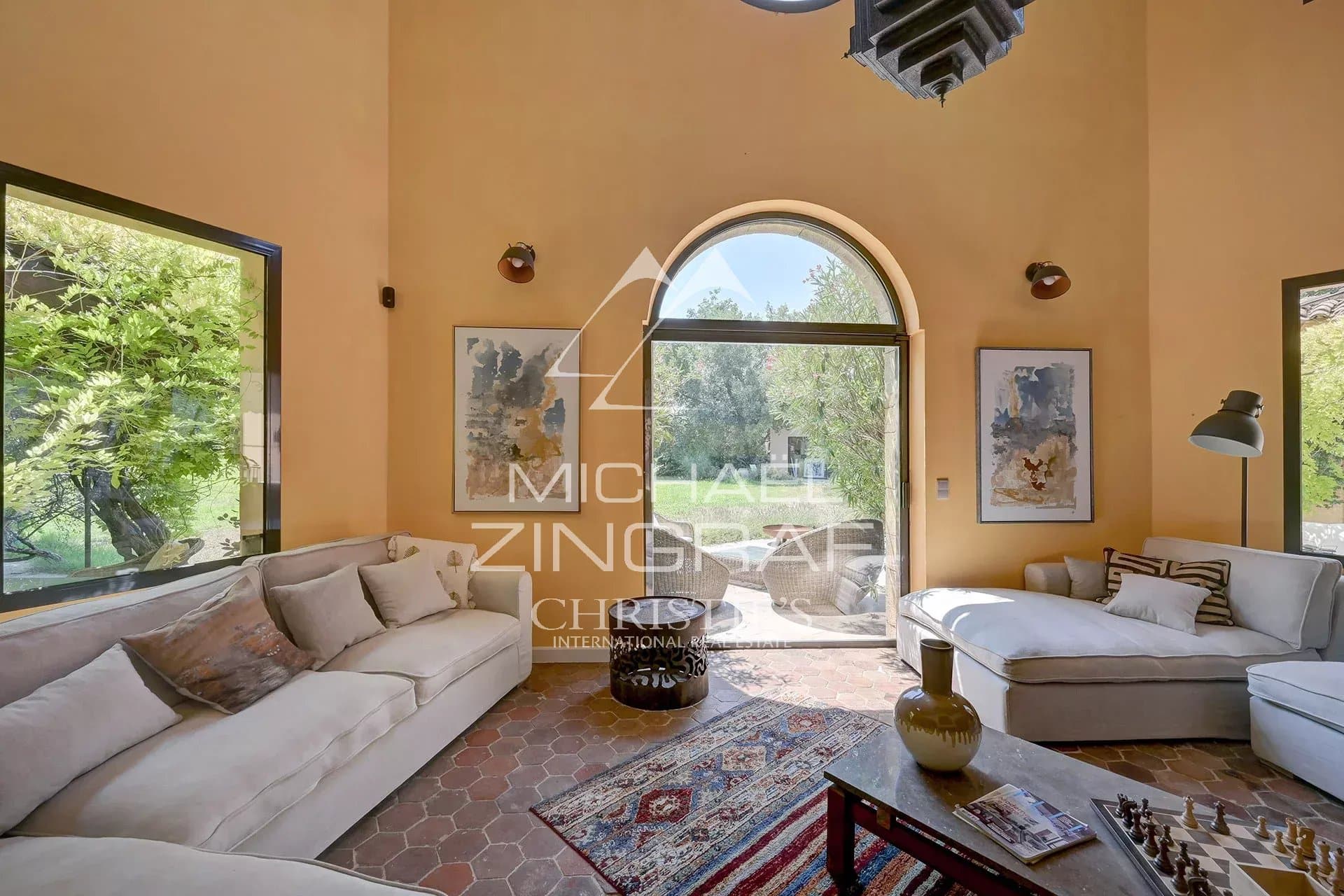 Bright interior of a luxury property with comfortable living room and large windows.