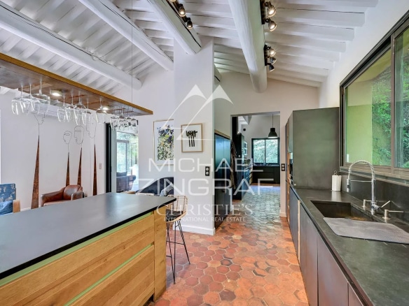 Interior of a modern kitchen with a wooden bar and contemporary design elements.