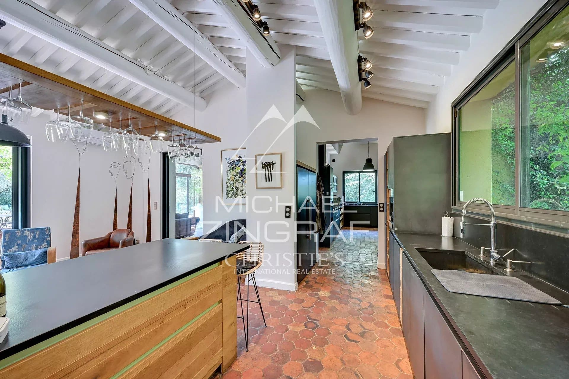 Interior of a modern kitchen with a wooden bar and contemporary design elements.