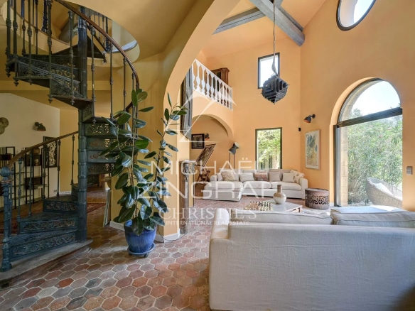 Interior of a luxury property with a spiral staircase and a bright living room in Aix-en-Provence.