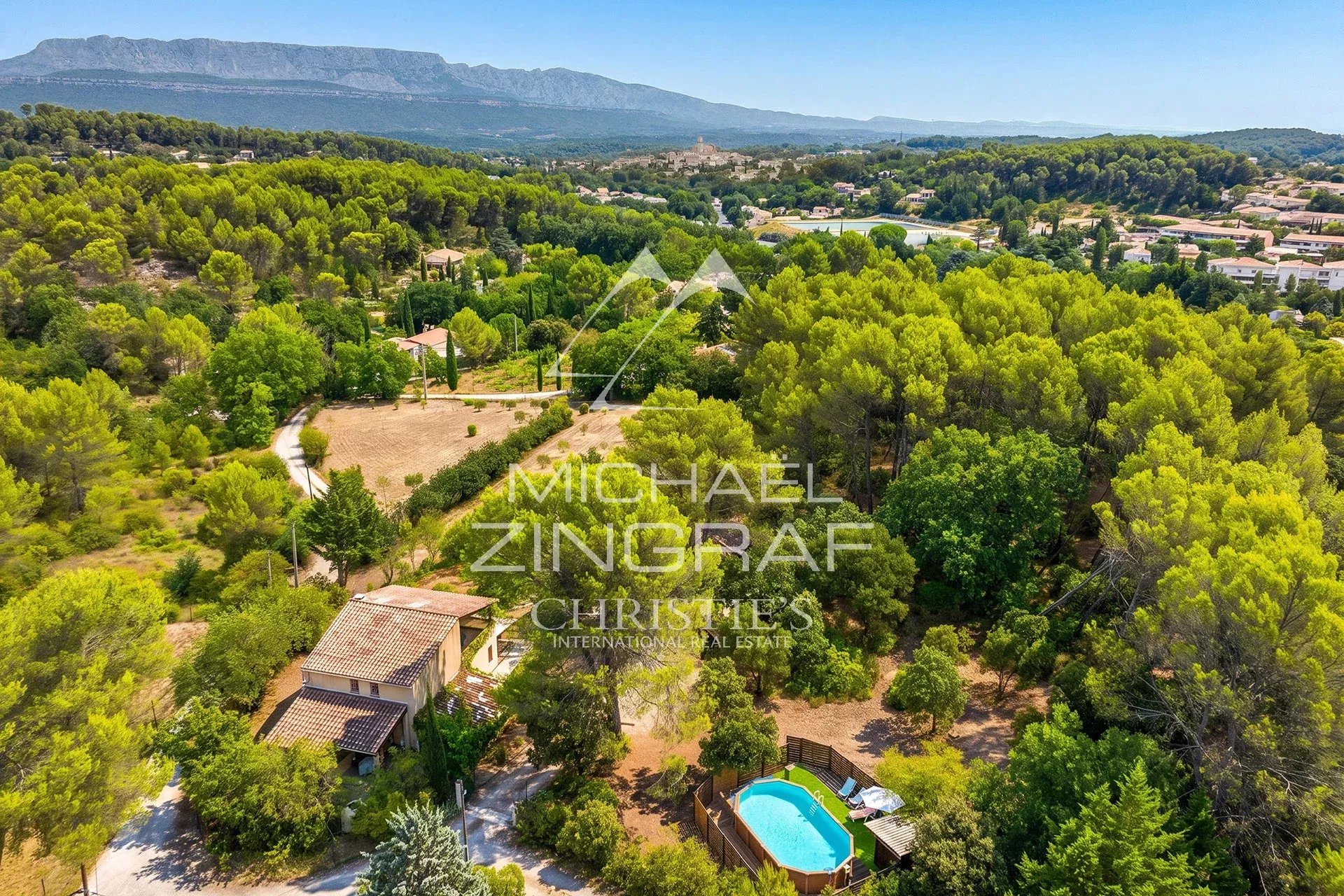 Aerial view of a family home with two apartments and a swimming pool, surrounded by olive trees in Fuveau.