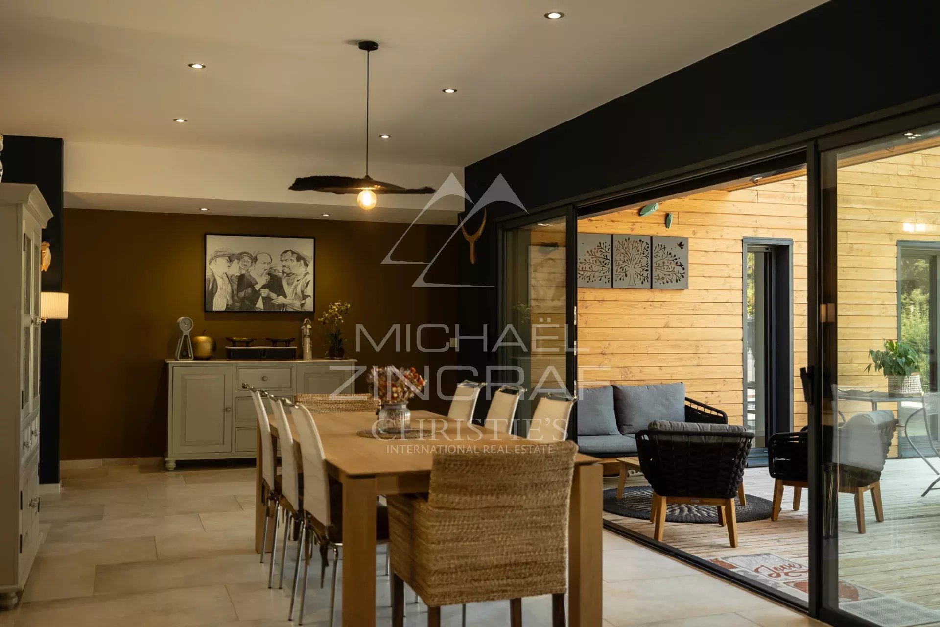 Interior of a contemporary property Interior of a contemporary house with dining room and access to a wooden terrace.