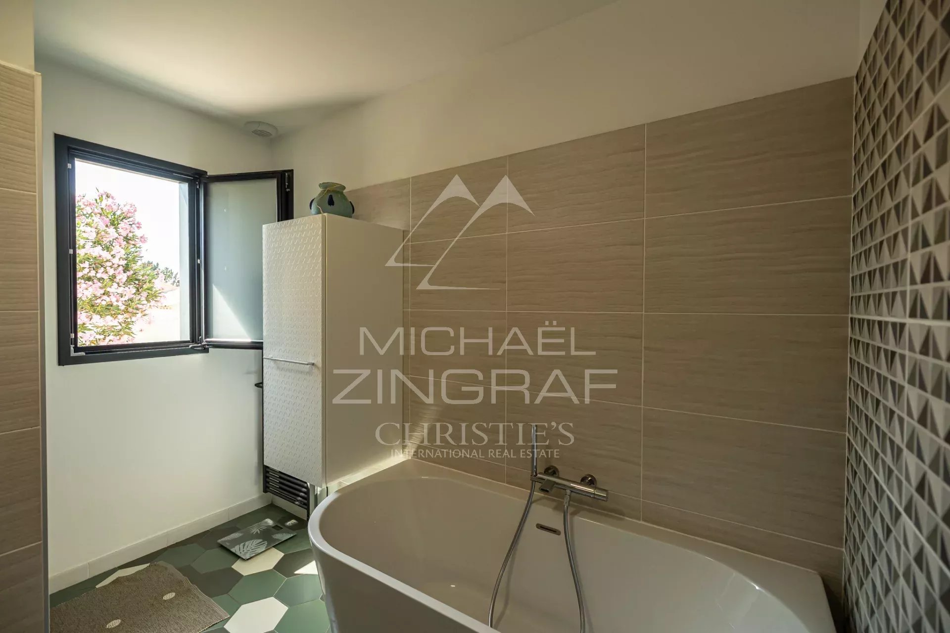 Contemporary bathroom Modern bathroom with bathtub and open window, decorative tiling.