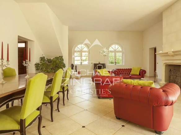 Interior of a bourgeois house with a bright living room, modern furniture and a fireplace.