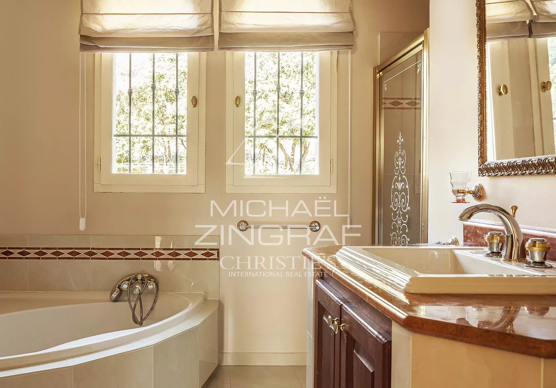 Bathroom in a bourgeois property Elegant bathroom with bathtub and window letting in light.