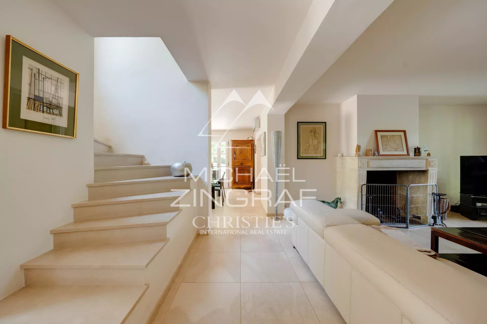 Interior of a property in Aix-en-Provence Interior of a property in Aix-en-Provence with a bright living room and marble staircase.
