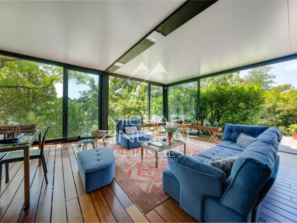 Interior of an elegant property with a bright living room and a view of a green park.