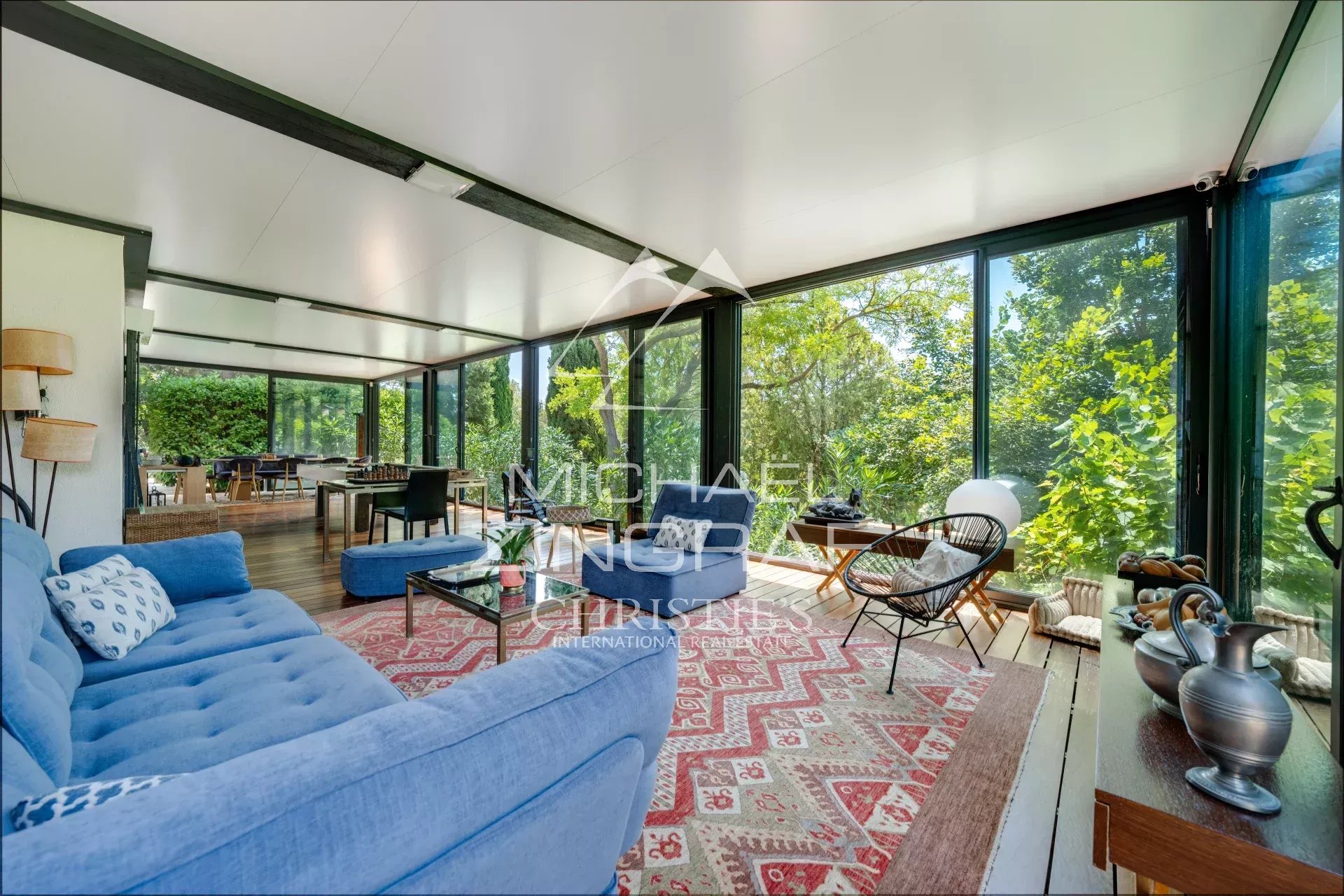 Bright living room of a property in Aix-en-Provence Interior of a property in Aix-en-Provence with a bright living room and large bay windows.