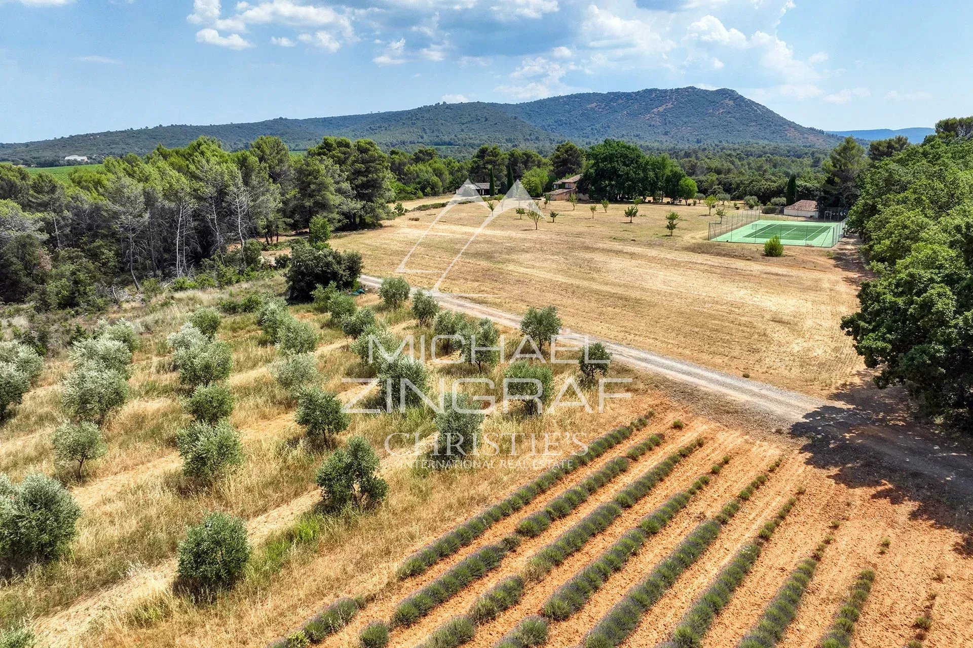 19th-century Provençal country house in Jouques Aerial view of a 19th century country house surrounded by an estate with olive trees and a tennis court.