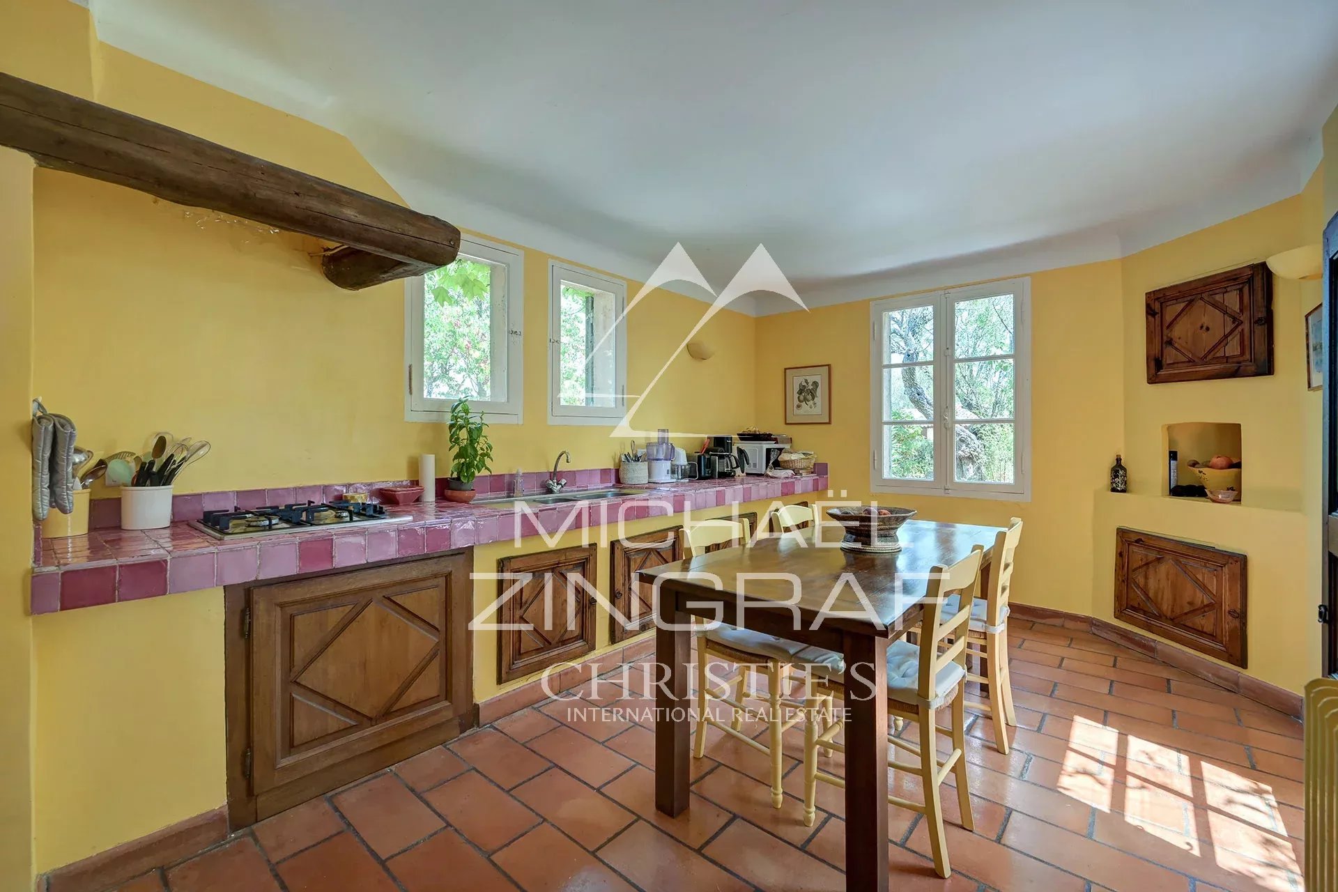 Kitchen of a Provençal country house Kitchen of a Provençal country house with yellow walls and a wooden table, Jouques