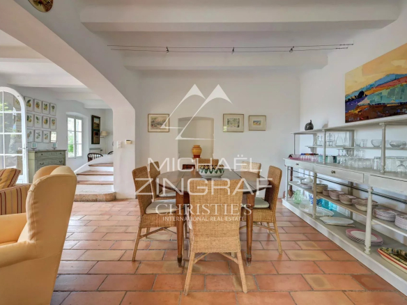 Interior of a Provençal country house with dining room and warm decor.
