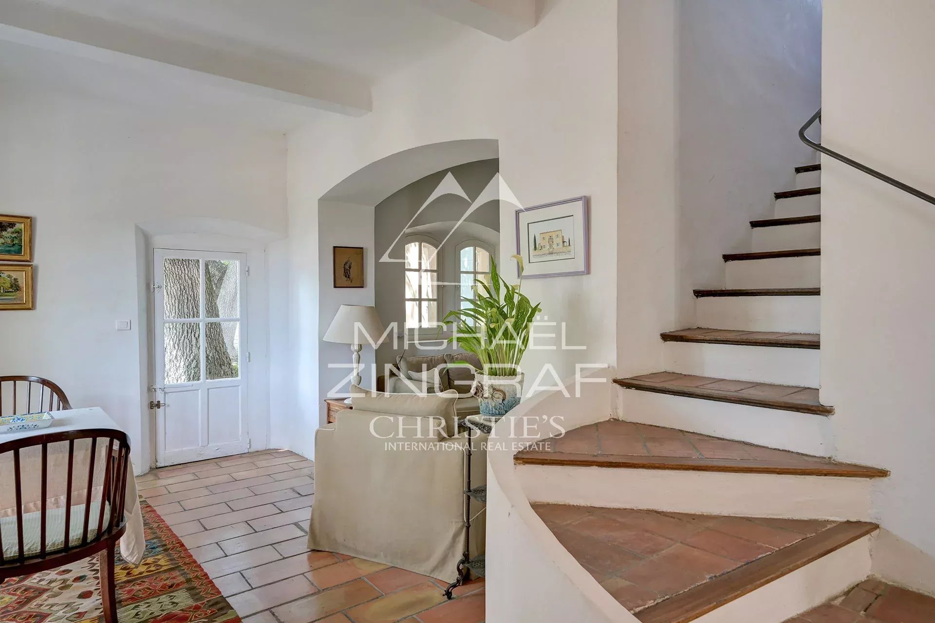 Interior of a 19th-century country house Interior of a Provençal country house with a staircase and a sitting area.
