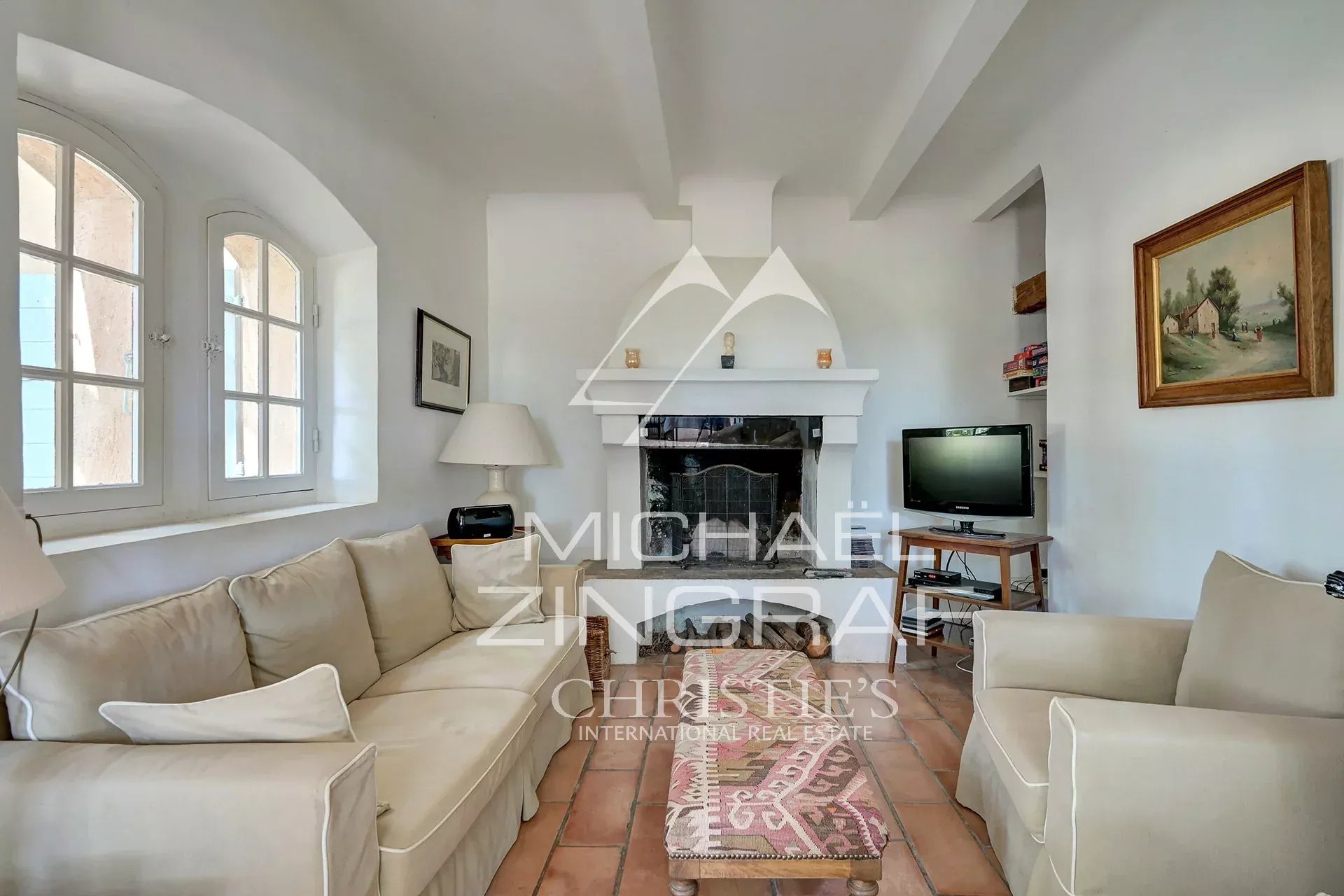 Living room of a Provençal country house Interior of a 19th century Provençal country house with a bright living room and a fireplace.