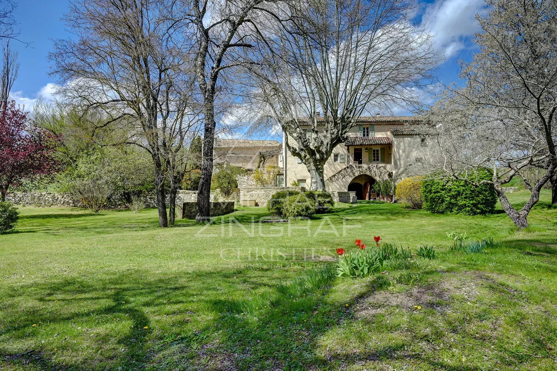 A renovated 17th-century mill in a green park in Forcalquier