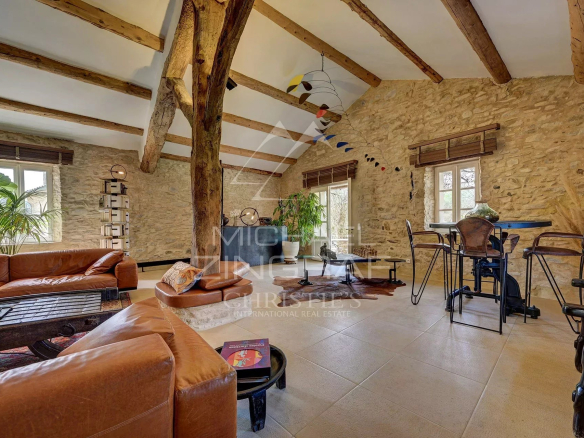 Interior of a renovated 17th-century mill, with exposed beams and modern furnishings.