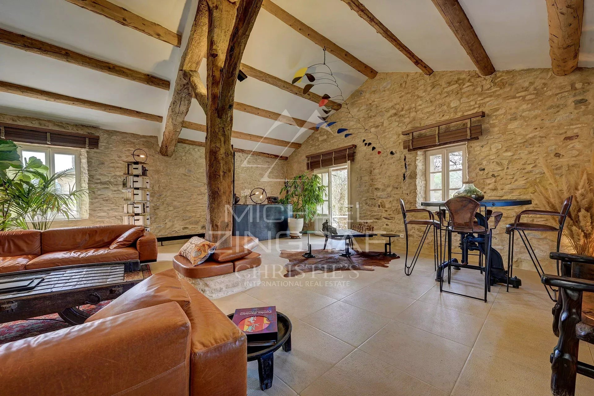 Interior of a renovated 17th-century mill, with exposed beams and modern furnishings.