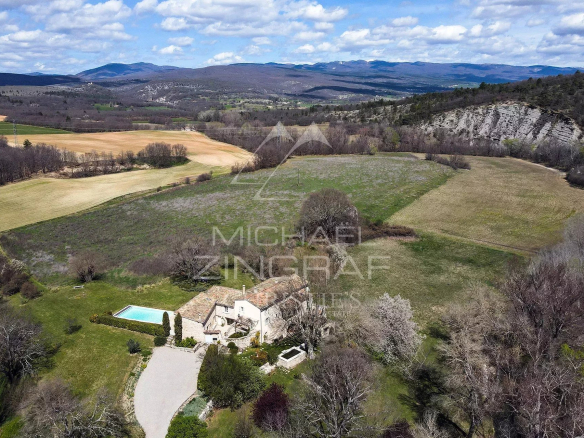 A renovated 17th-century mill in a green landscape near Forcalquier.