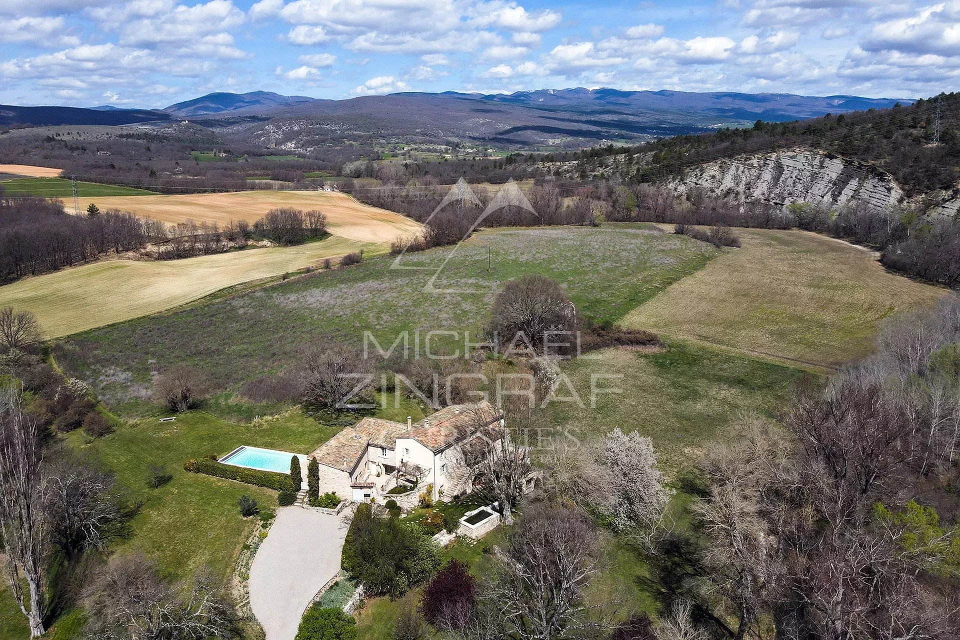 A renovated 17th-century mill in a green landscape near Forcalquier.