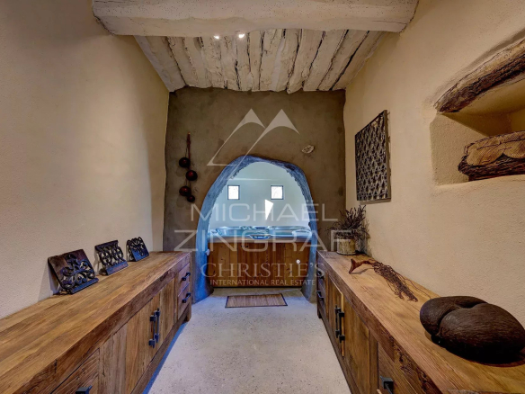 Interior of a renovated 17th-century mill, with stone walls and wooden furniture.