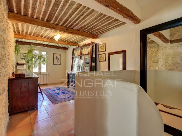 Renovated interior of a 17th century mill with stone walls and exposed beams.