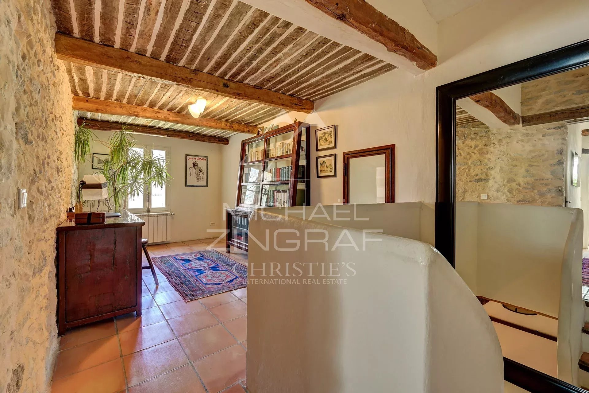 Renovated interior of a 17th century mill with stone walls and exposed beams.