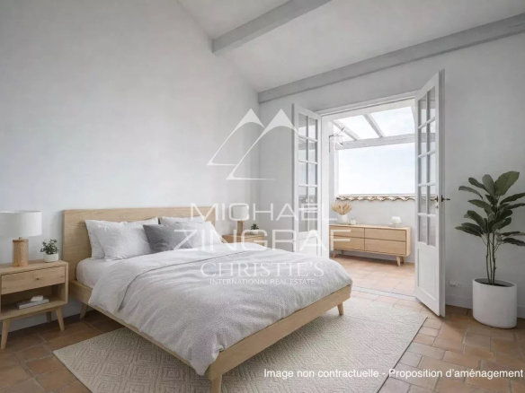 Bright room with double bed and wooden furniture, windows opening onto an outdoor space.