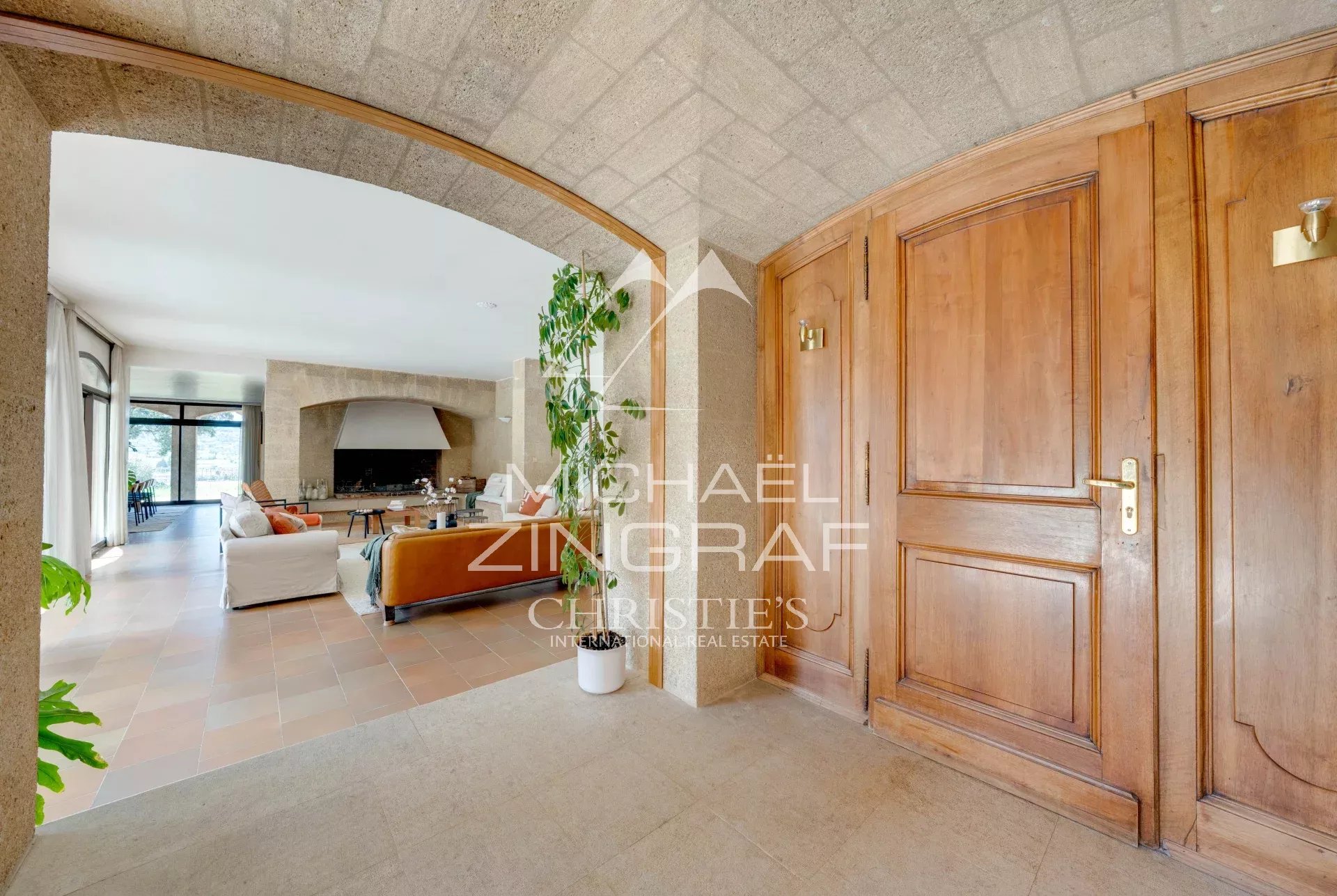Interior of a 1970s property Interior of a 1970s house with stone walls and wooden doors, bright living room.