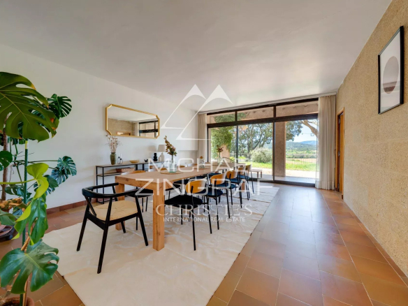 Interior of a 1970s house overlooking a landscaped park.