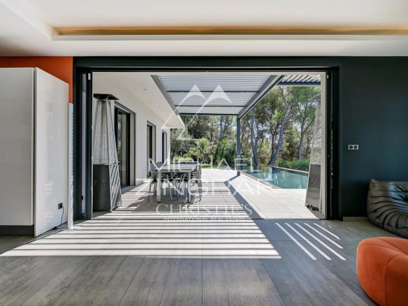 Interior of a contemporary villa overlooking a terrace and swimming pool, Aix-en-Provence.