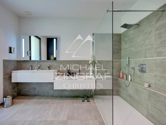 Modern bathroom with walk-in shower and double vanity in a contemporary villa.