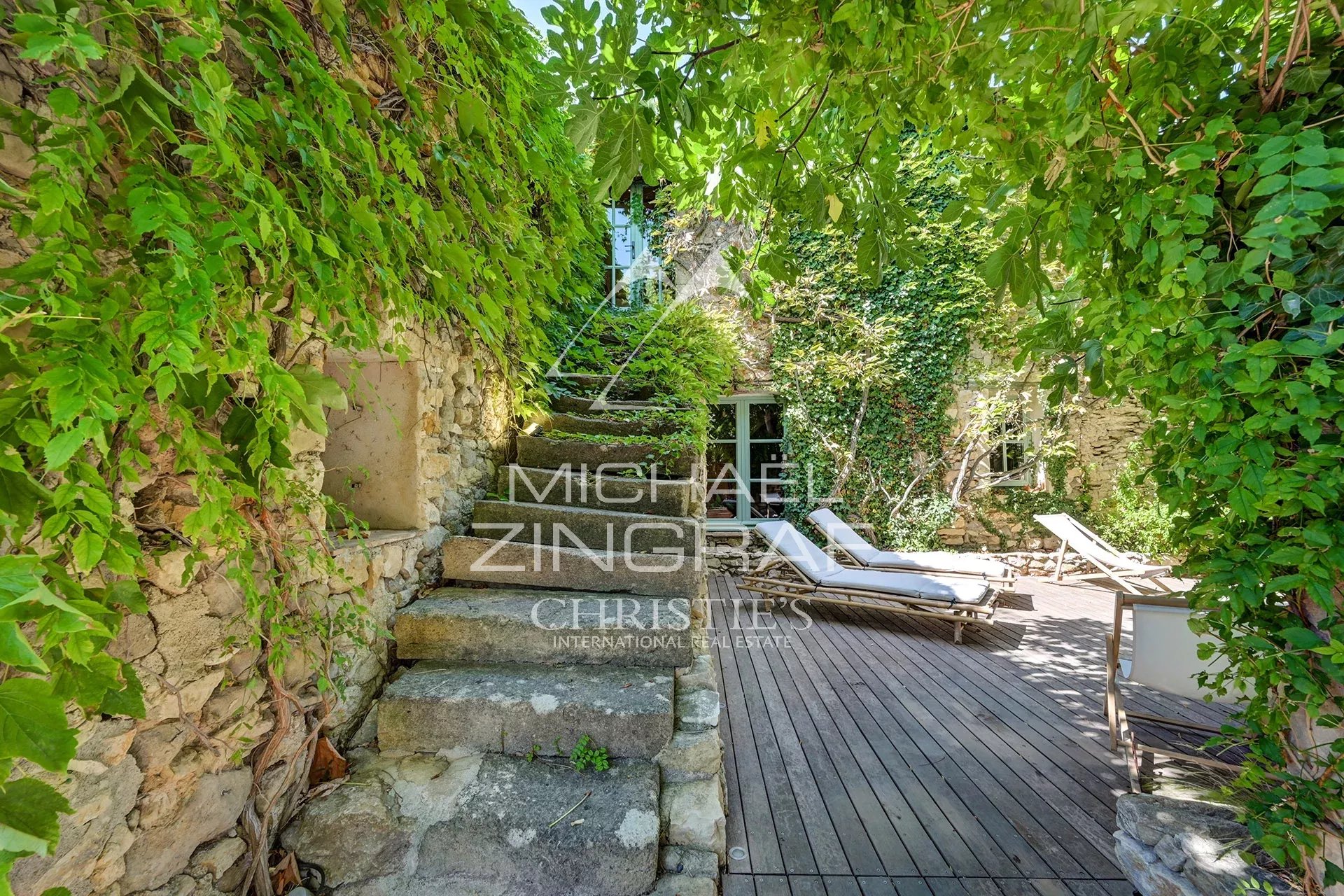 Stairs to the silkworm farm terrace Stone steps leading to a terrace with sun loungers, surrounded by greenery