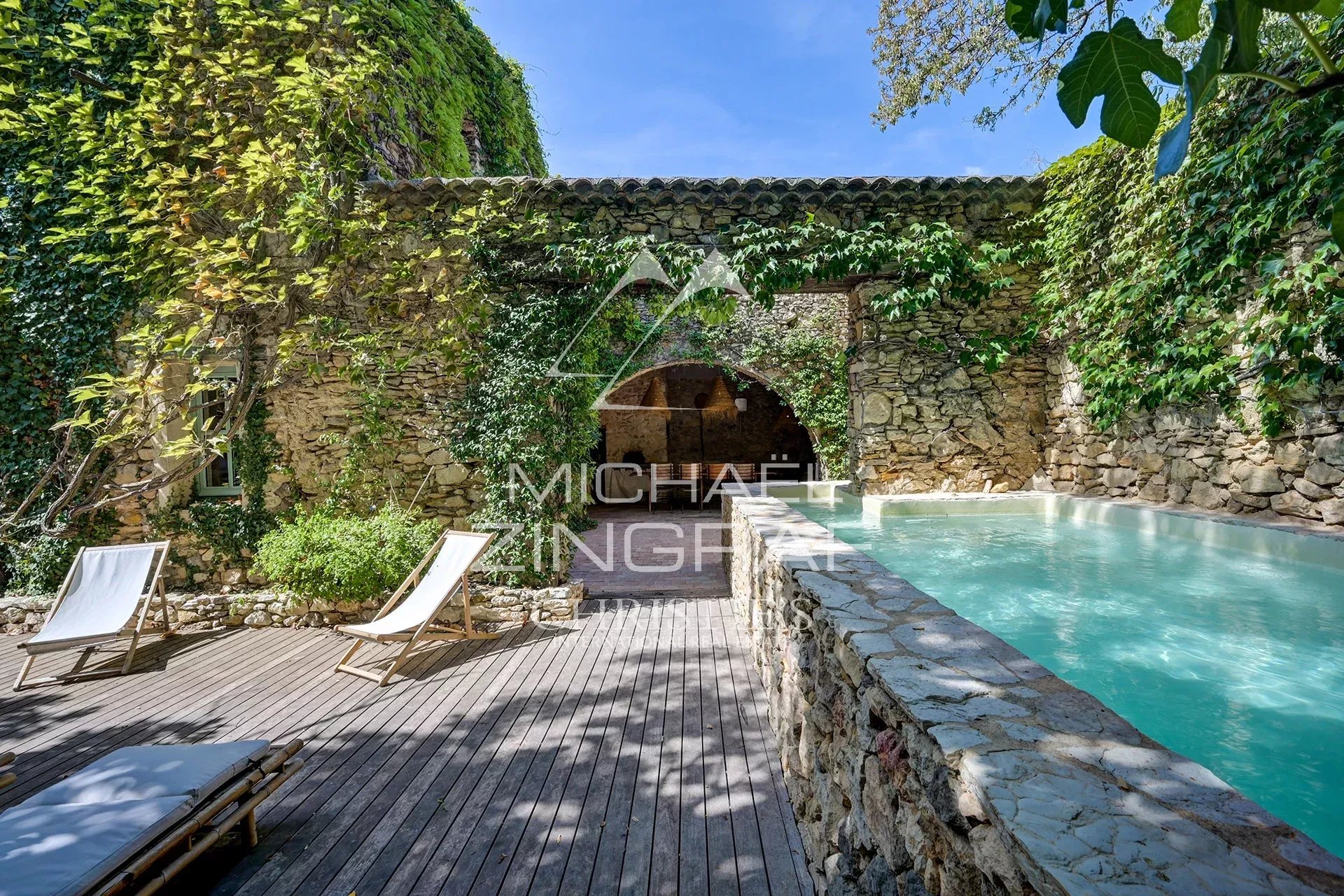 Renovated property with swimming pool in La Fare-les-Oliviers Swimming pool surrounded by stone walls and greenery in a renovated property in La Fare-les-Oliviers.
