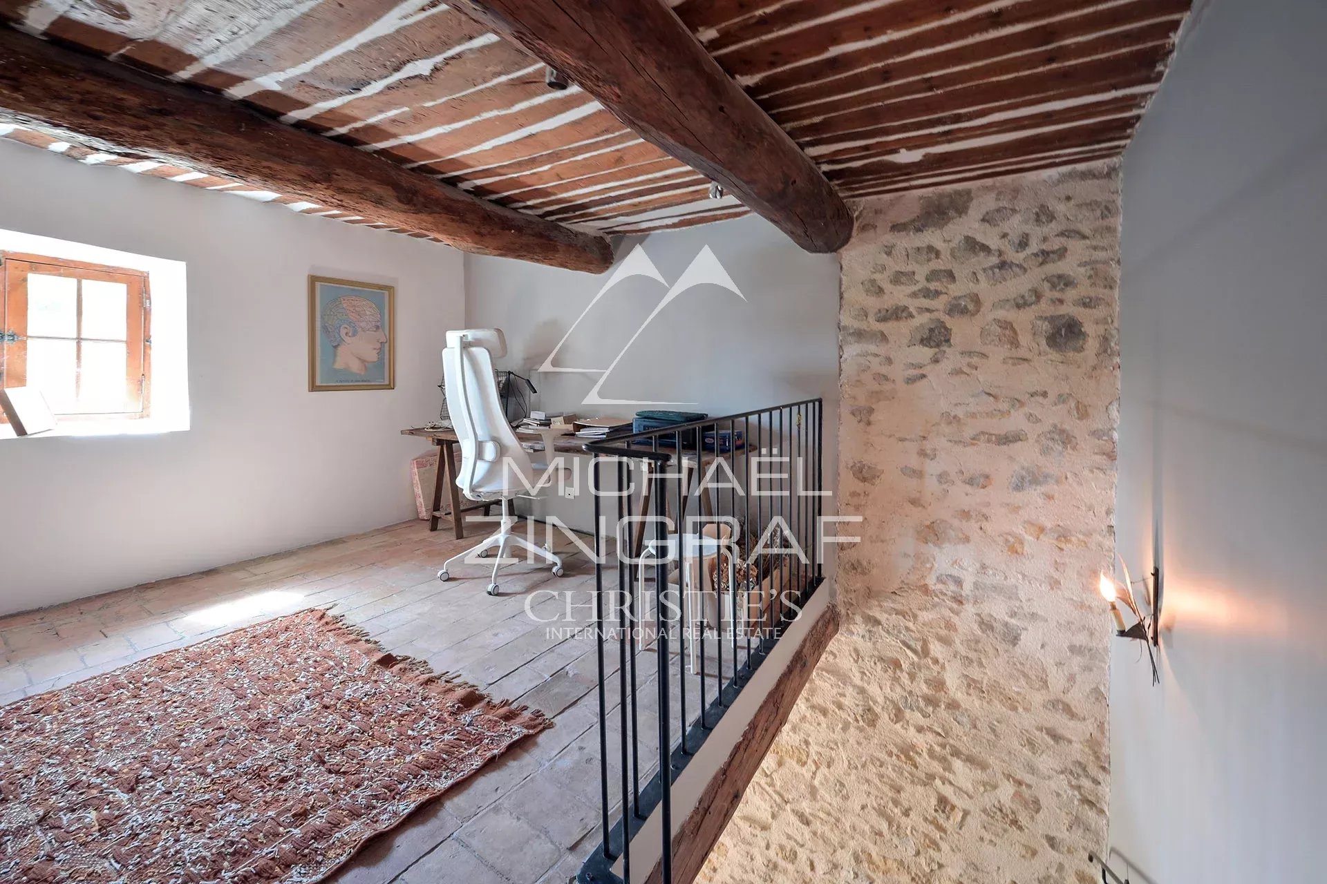 Interior of a renovated silkworm farm Interior of a renovated silkworm farm with exposed beams and a bright workspace.