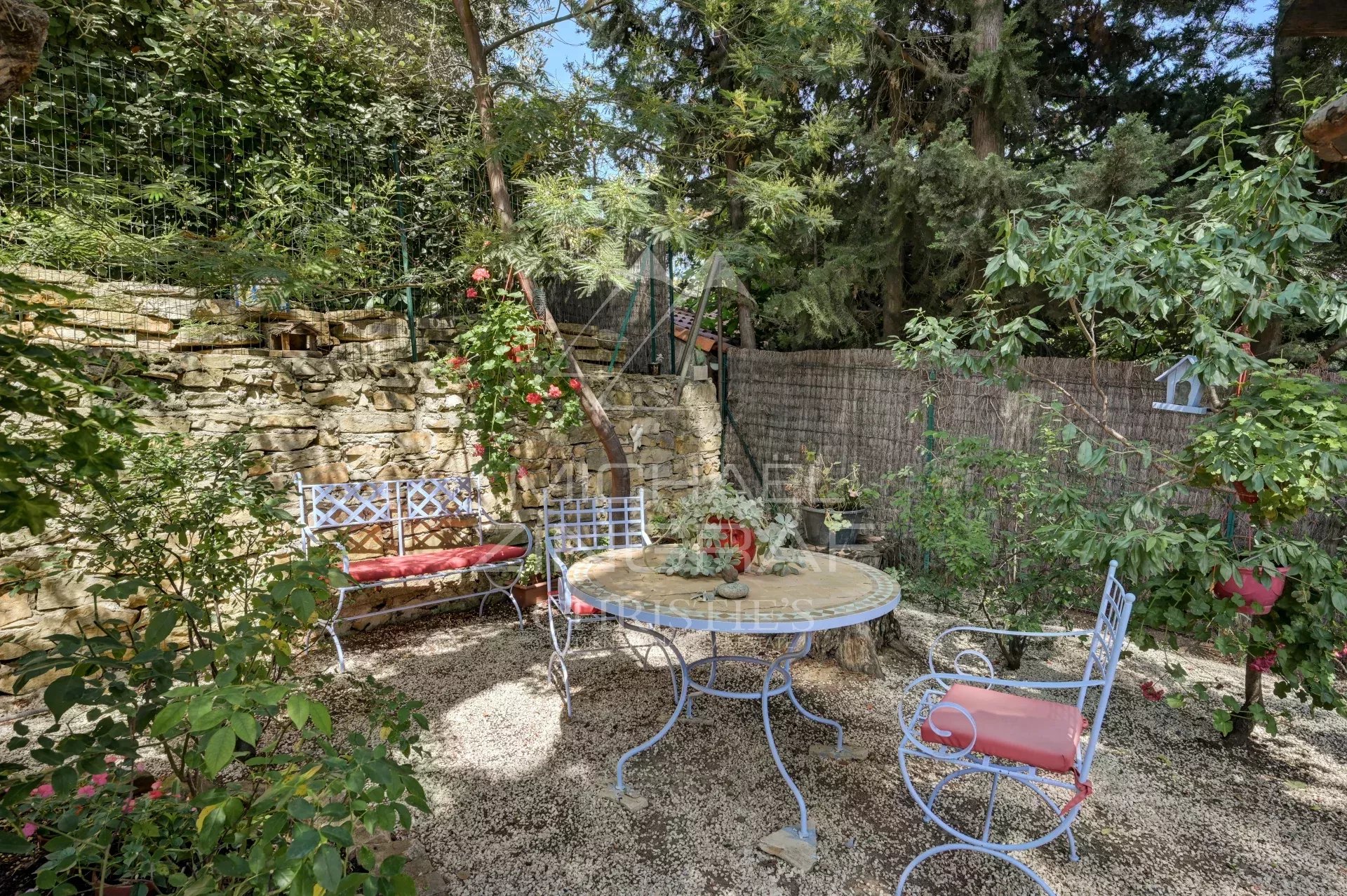 Landscaped garden in La Ciotat Outdoor space with wrought iron table and chairs in a landscaped garden in La Ciotat.
