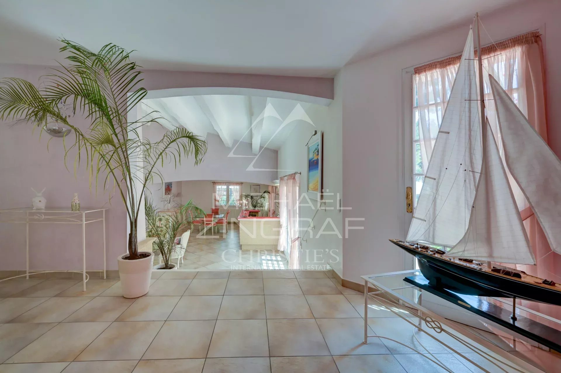 Interior of a villa in La Ciotat Interior of a villa in La Ciotat with modern decor and a model boat.