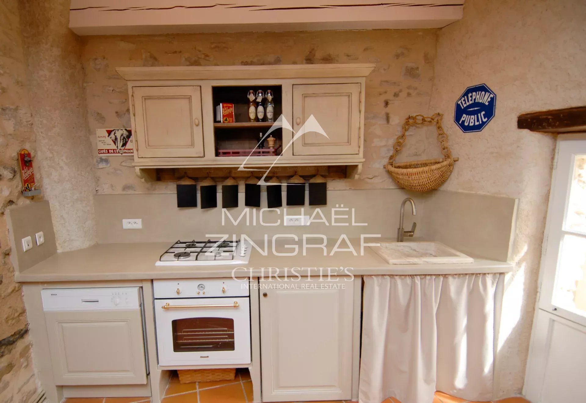 Kitchen of a renovated mill Renovated kitchen of a 17th century mill in Forcalquier, with modern elements and old-world charm.