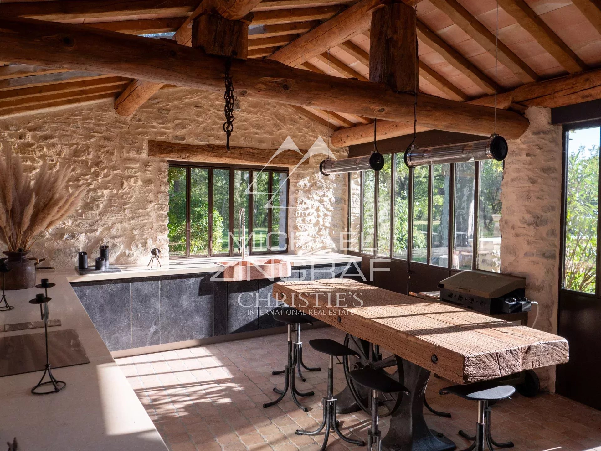 Renovated interior of a 17th-century mill Interior of a renovated 17th-century mill with modern kitchen and views of nature.