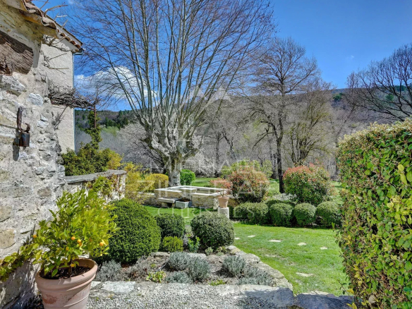 Renovated 17th century mill with green garden in Forcalquier, surrounded by nature.
