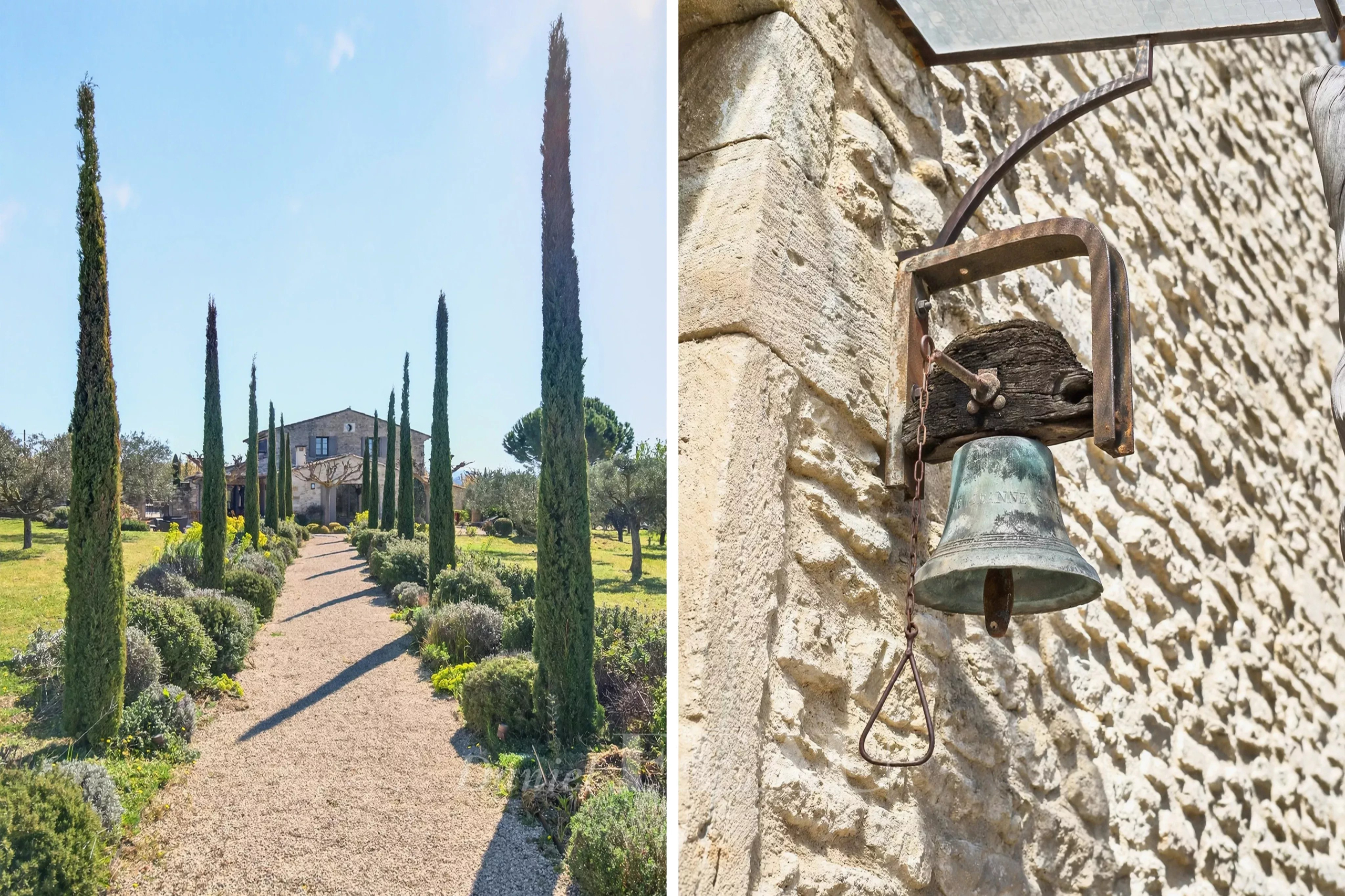 Path lined with tall cypress trees leading to a stone house in a sunny garden. A gravel walkway and manicured shrubs frame the scene.