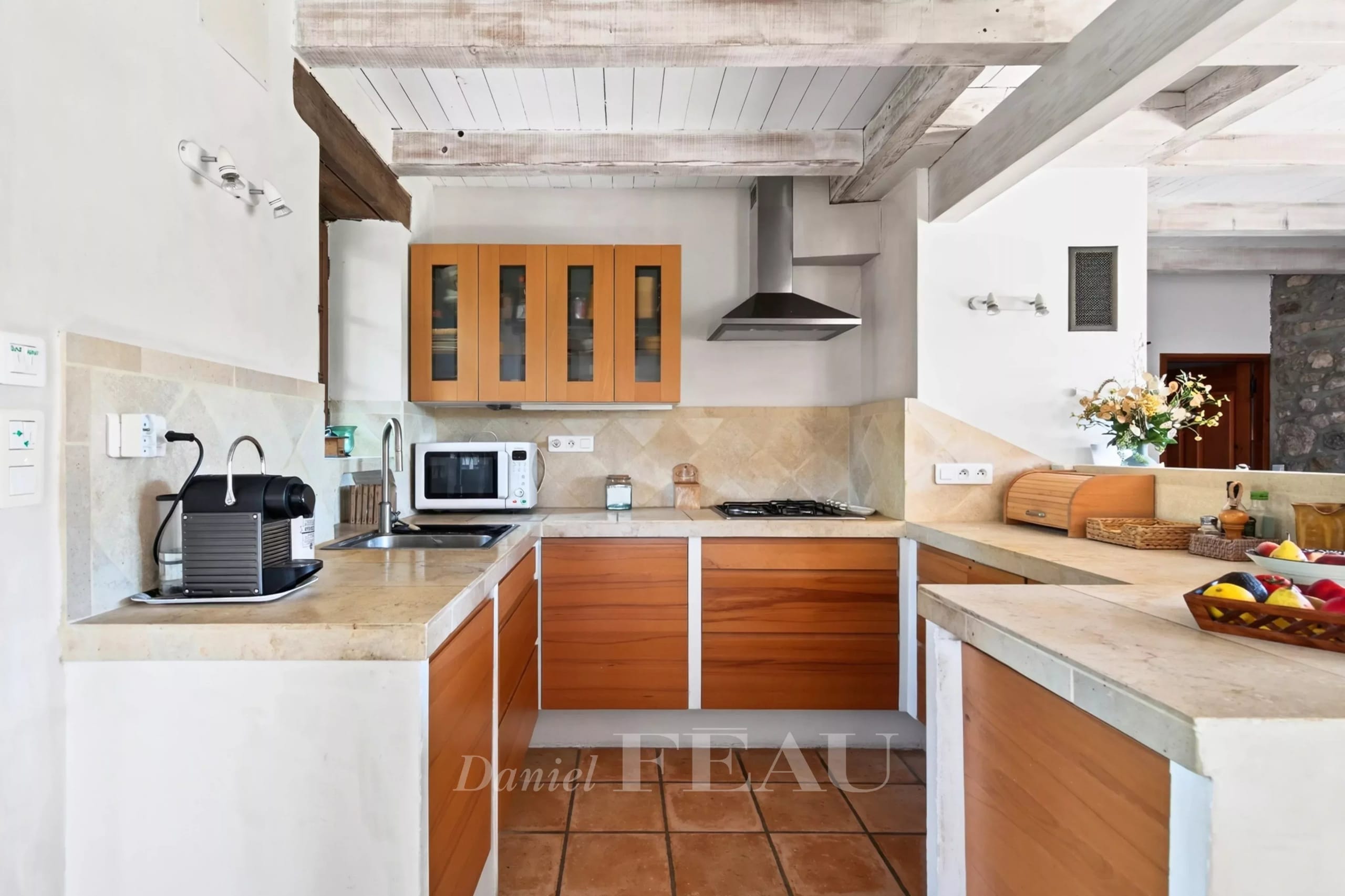 Modern kitchen with wooden furniture and appliances, in a house in Montjustin.