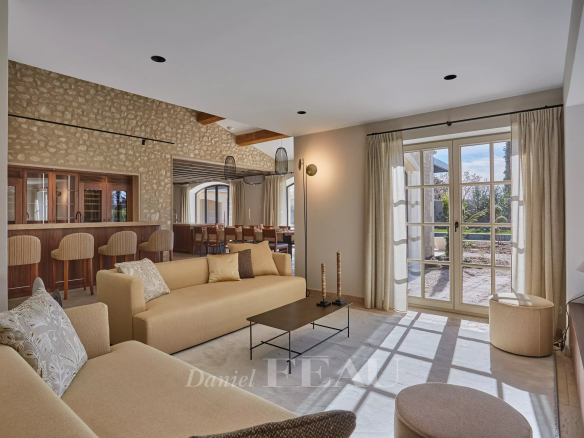 Interior of a renovated stone house with a bright and modern living room in Maussane-les-Alpilles.