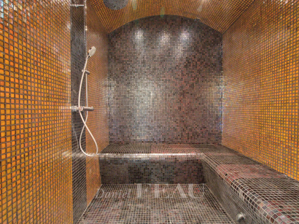 Intérieur d'un hammam avec mosaïque colorée et douche