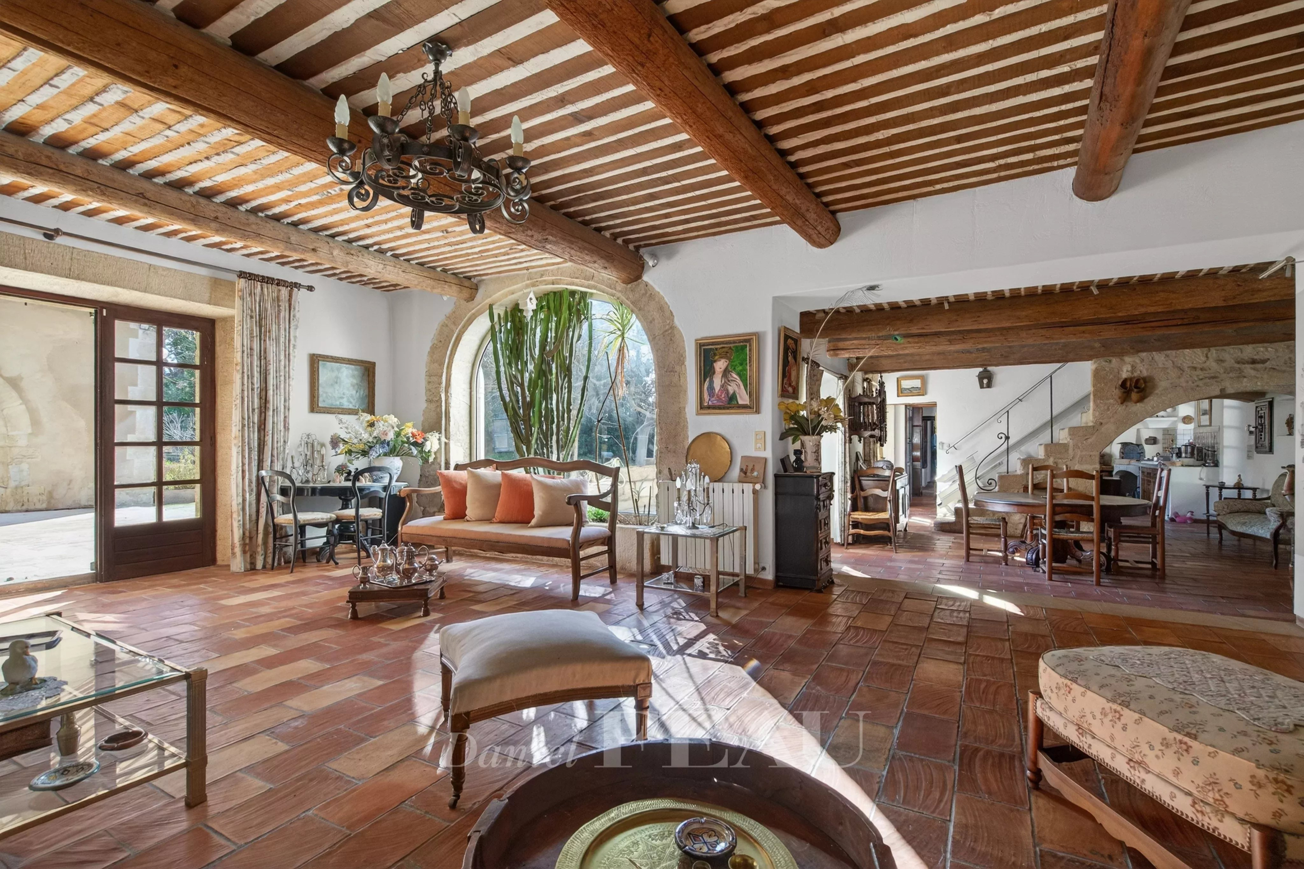 Interior of a Provençal farmhouse with exposed beams and traditional furniture.