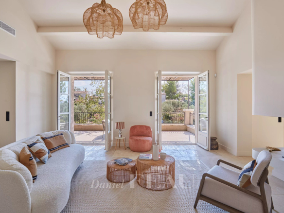 Interior of a renovated house with a bright living room and access to a terrace.