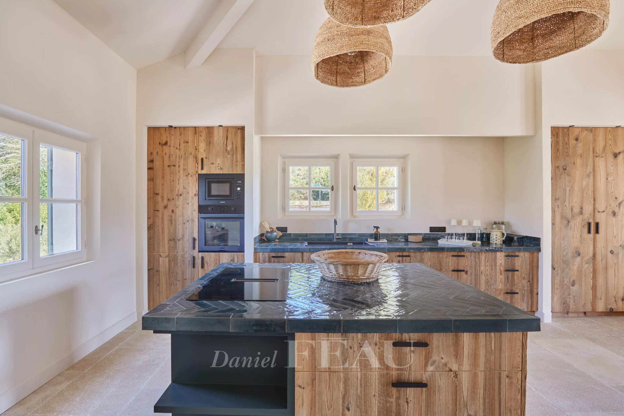 Renovated kitchen in Paradou Modern kitchen with central island and wooden furniture in a renovated house in Paradou.