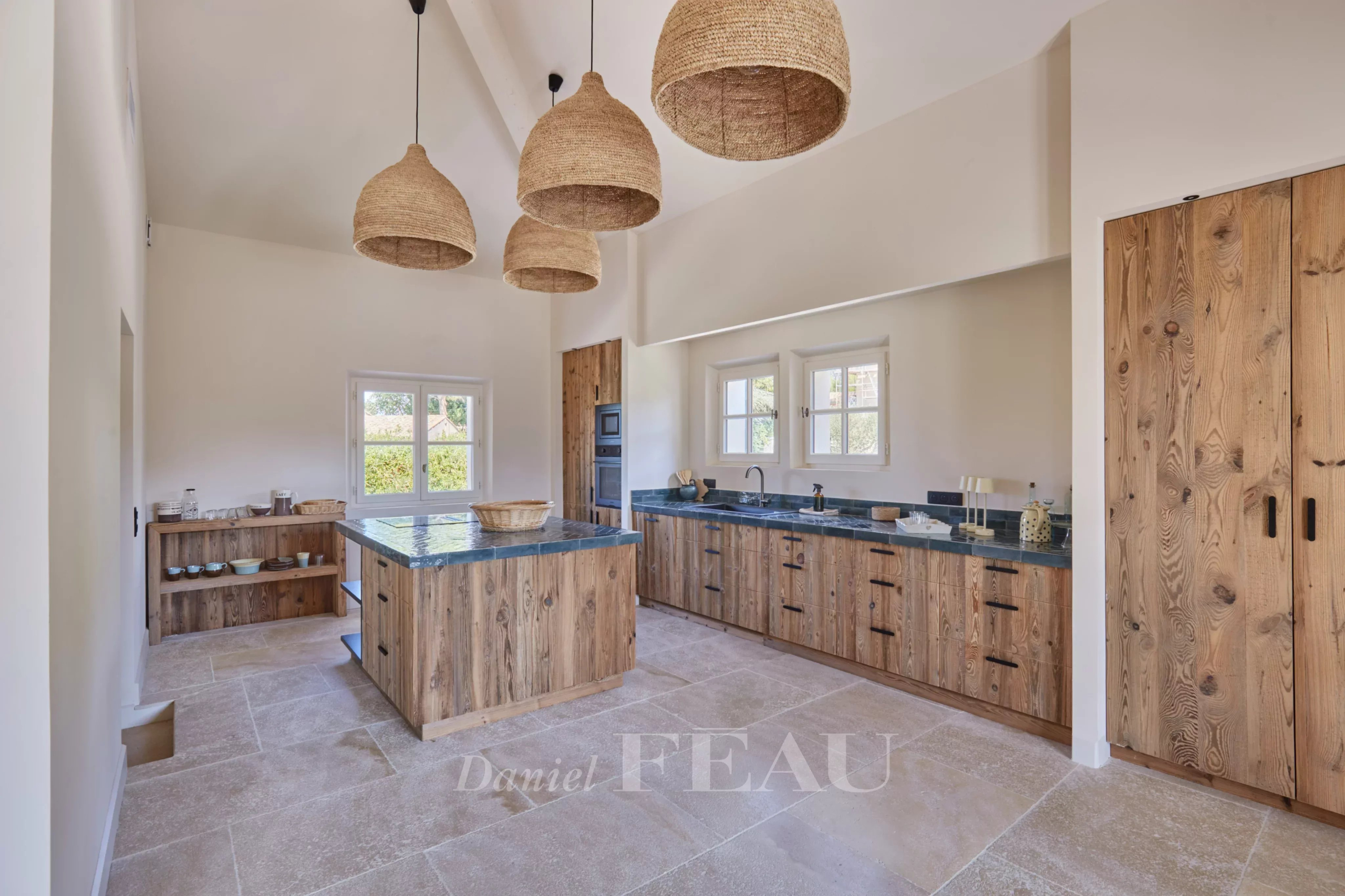 Renovated kitchen in Paradou Modern kitchen with central island and wooden furniture in a renovated house in Paradou.