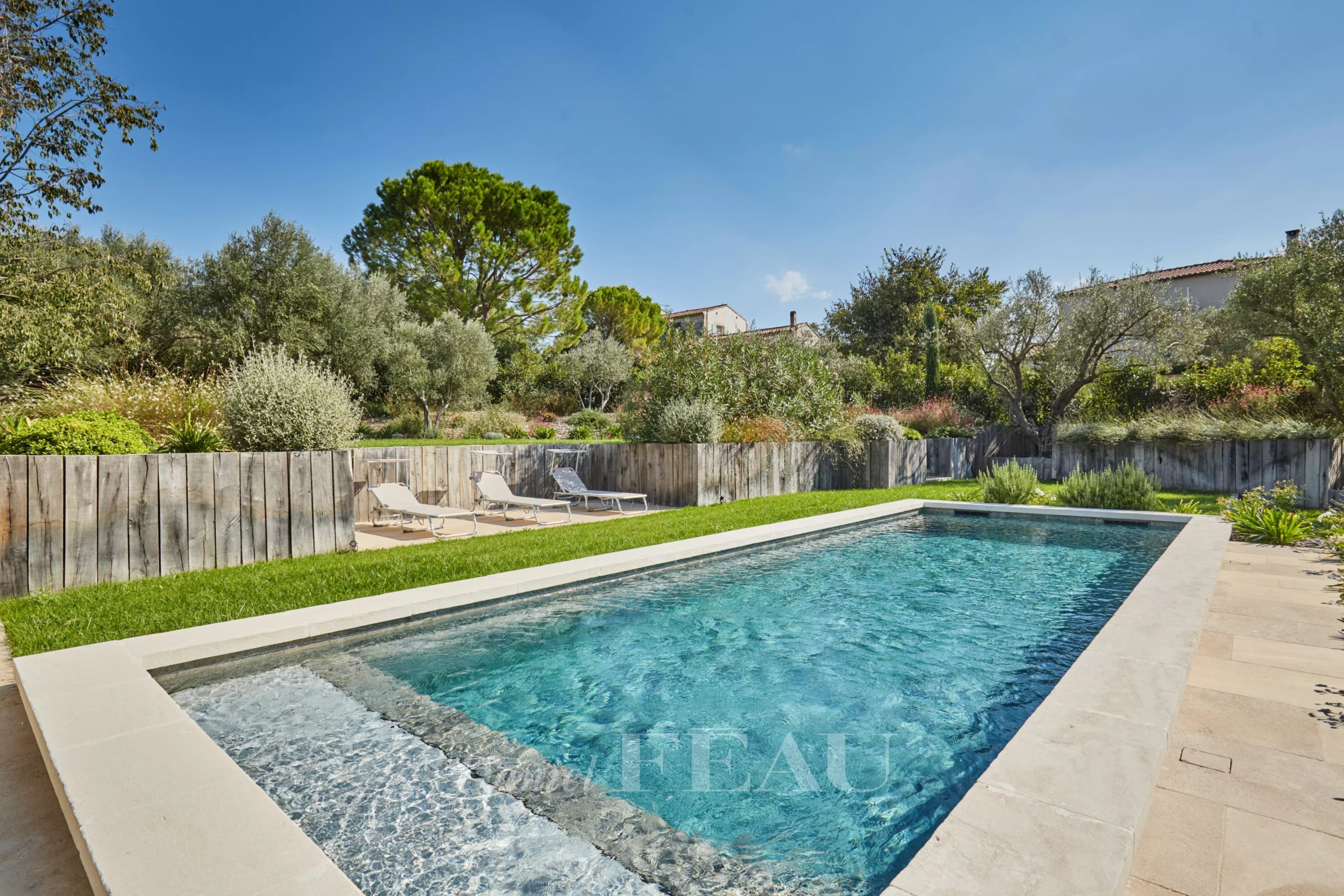 Swimming pool and Mediterranean garden Swimming pool in a Mediterranean garden with sun loungers and plants.