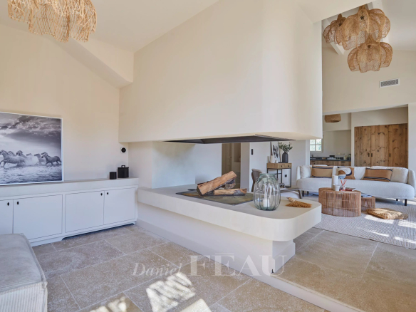 Interior of a renovated house with a modern fireplace and bright decor.