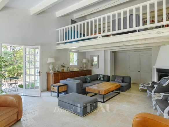 Interior of a property with a spacious living room, modern furniture and natural light.