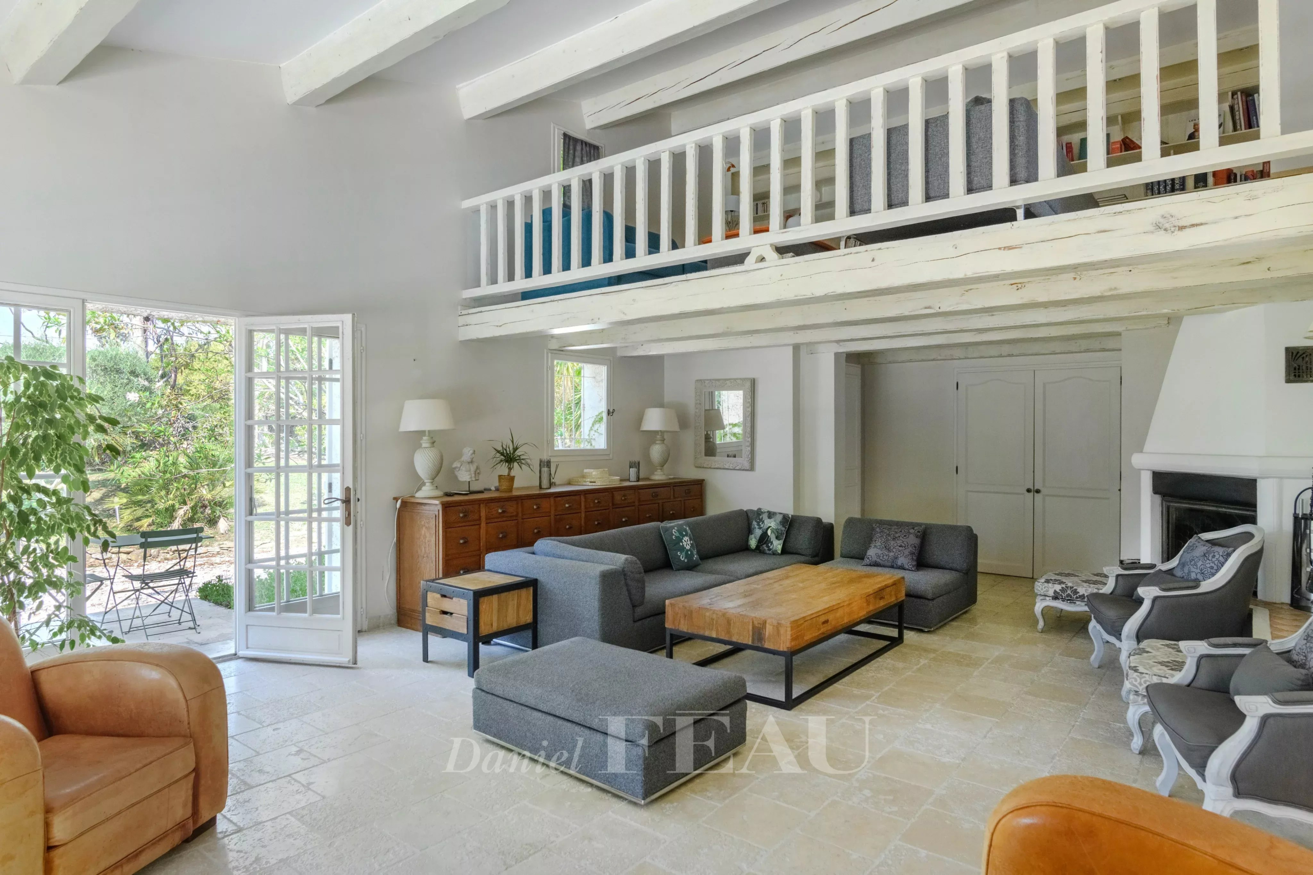 Interior of a property with a spacious living room, modern furniture and natural light.